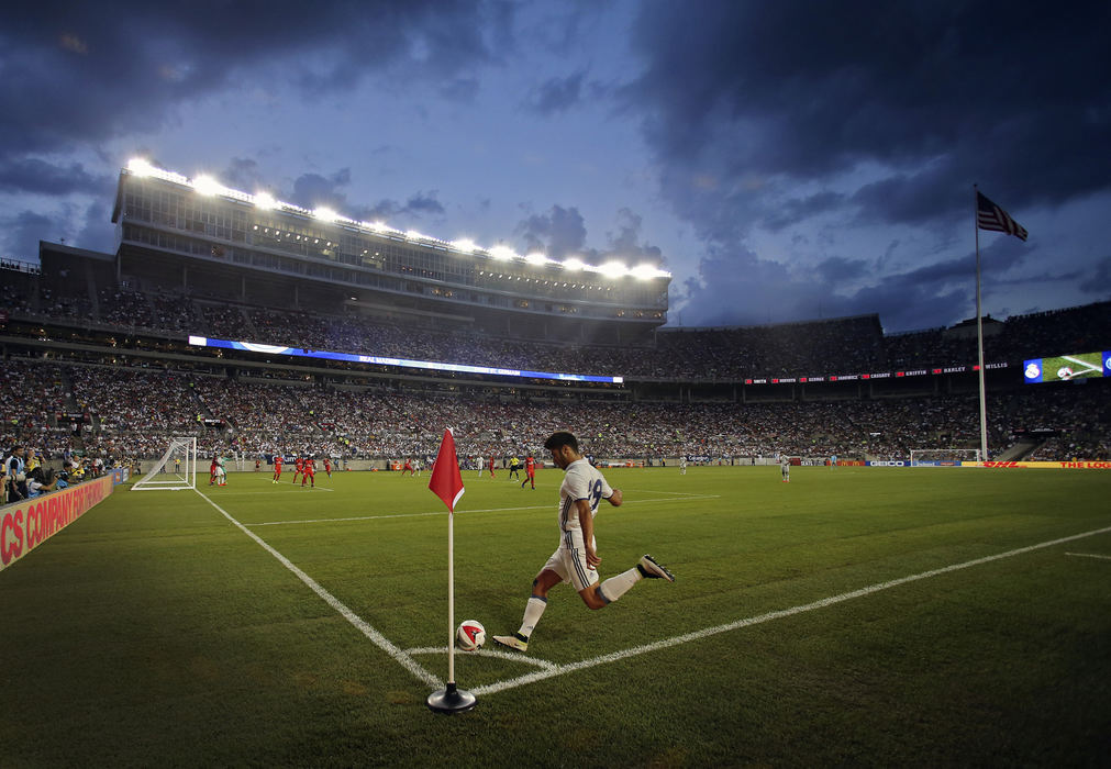 Second Place, Photographer of the Year - Large Market - Kyle Robertson / The Columbus Dispatch Real Madrid midfielder Marco Asensio (28) takes a corner kick against Paris Saint-Germain in the 2nd half at Ohio Stadium on July 27, 2016. The college football cathedral drew an announced crowd of 86,641, the largest to witness a soccer game in Ohio. The game was also the first soccer game at Ohio Stadium since 1999.  