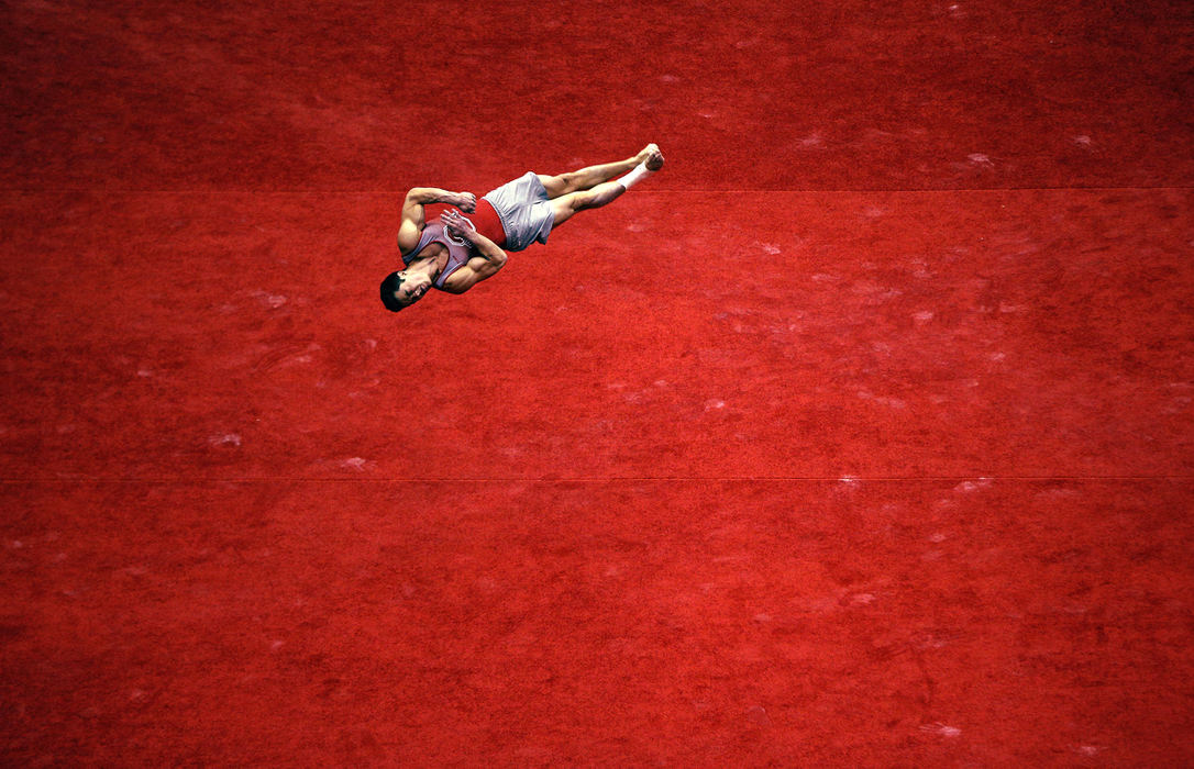 Second Place, Photographer of the Year - Large Market - Kyle Robertson / The Columbus Dispatch Ohio State's Sean Melton flips during floor event at the Team Finals at the Big Ten Championships at St. John Arena in Columbus, Ohio on April 1, 2016.  Melton won this event with a score of 15.400.  Ohio State won the team contest with a score of 434.450 over second place Illinois 429.700.  Melton also had the top All-Around score of 89.750.  