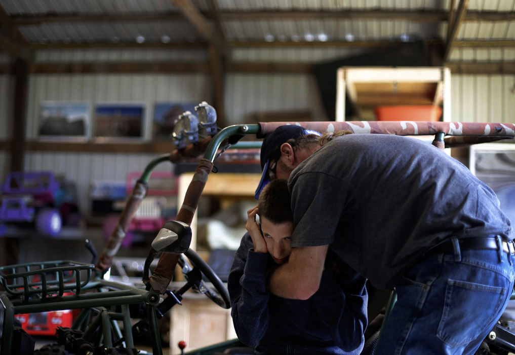 Second Place, Photographer of the Year - Large Market - Kyle Robertson / The Columbus Dispatch Rocky Grimes, right, takes a moment to hold Michael Fuller, center, who has genetic chromosomal after a go-cart session was over on a farm in Mechanicsburg, Ohio on October 3, 2016.  Michael was sad because he knew his time was up on the go-cart.  