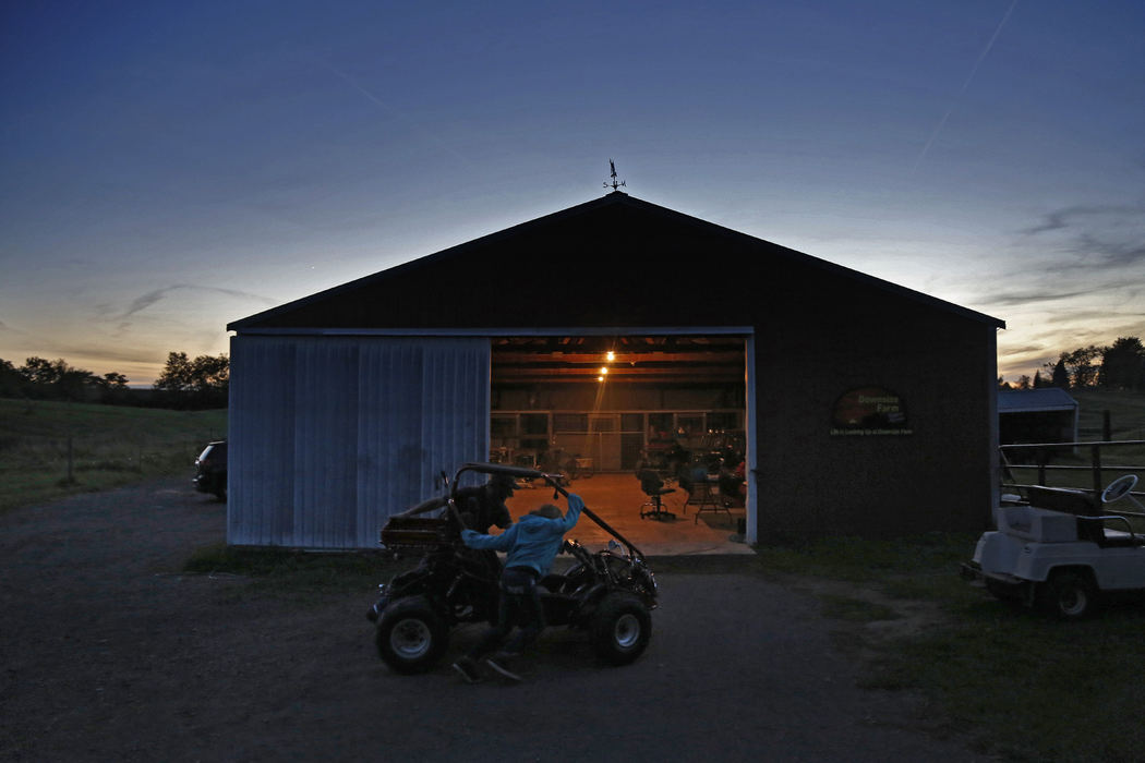 Second Place, Photographer of the Year - Large Market - Kyle Robertson / The Columbus Dispatch After the final client is gone Rocky Grimes and his daughter Julia, 10, pushes a go-cart back into the barn for the night on a farm in Mechanicsburg, Ohio on October 10, 2016. 