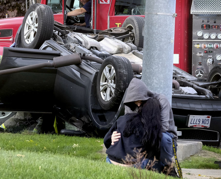 Third Place, Photographer of the Year - Large Market - Andy Morrison / The (Toledo) BladeMeagan Insco, 17, is consoled following a rollover accident at the corner of Manhattan and Stickney, Tuesday, October 11, 2016. Toledo police said the young woman was traveling westbound on Manhattan and turned in front of another vehicle. They cited her for failure to yield during a left turn. 