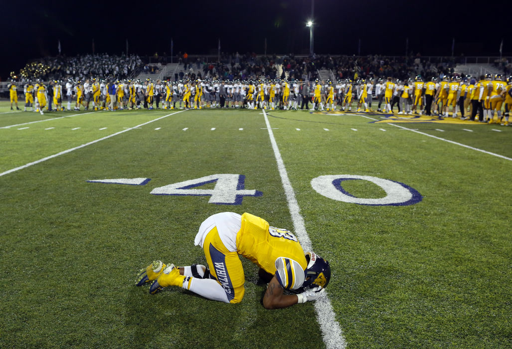 Third Place, Photographer of the Year - Large Market - Andy Morrison / The (Toledo) BladeToledo Whitmer High School player Shoe Sanders reacts after the Panthers season ending loss to Medina High School during their Division I football game at Whitmer High School.
