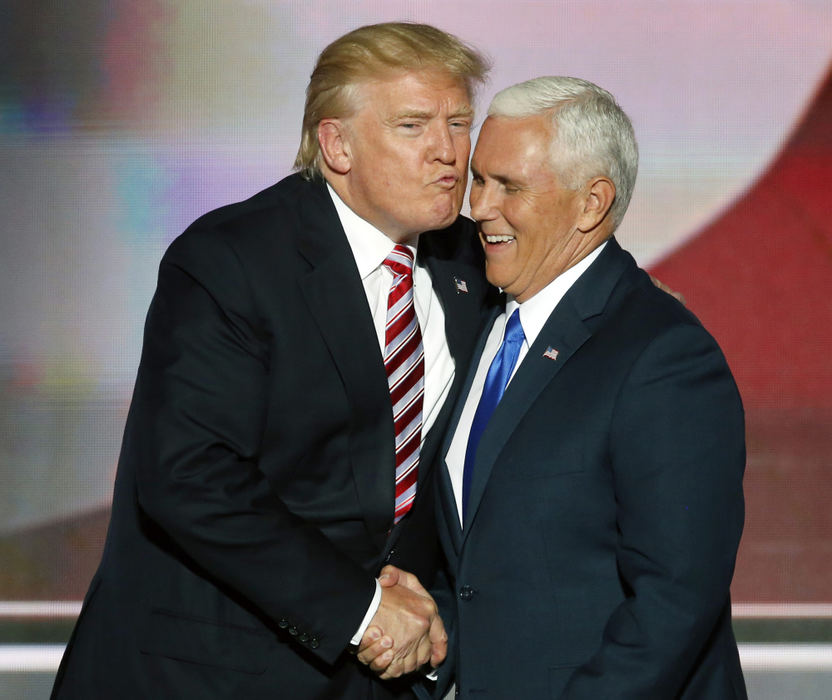 Award of Excellence, Photographer of the Year - Large Market - Gus Chan / The Plain DealerDonald Trump attempts an awkward embrace and air kiss with his vice-presidential nominee, Mike Pence, during the third night of the Republican national convention in Cleveland. Mike Pence formally accepted the nomination as vice-presidential candidate for the Republican party.