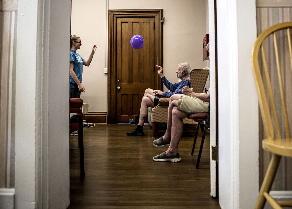 First Place, Photographer of the Year - Small Market - Jessica Phelps / Newark AdvocateAlyson Camelin, 17,, a summer intern at the Carol Strawn Center tosses a balloon around with Tom Engeman and other clients before beginning their daily exercise routine. Every day Tom is dropped off at the Carol Strawn Center which offers adult daycare specifically for clients with Alzheimer's and Dementia. 