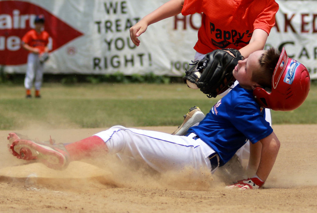 First Place, Photographer of the Year - Small Market - Jessica Phelps / Newark AdvocateLane Allen's helmut flies off as he is tagged by 3rd baseman, Brody White of Pappy's. Pappy's beat the Meyers team 11-10 in the farm division quarterfinals at the Shrine Tournament Saturday.