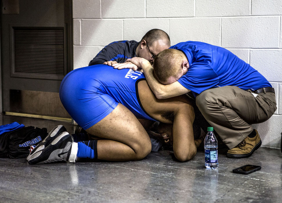 First Place, Photographer of the Year - Small Market - Jessica Phelps / Newark AdvocateLeo Crosby, a senior at Zanesville High School, is embraced by his coaches, Chris Miller andPat Lawson after failing to qualify for the final match at the 2016 state wrestling finals. Crosby was the wrestler from his school to qualify for the state meet in over 40 years. This year was his second and final chance to make the podium, but he fell just short of making the cut. 