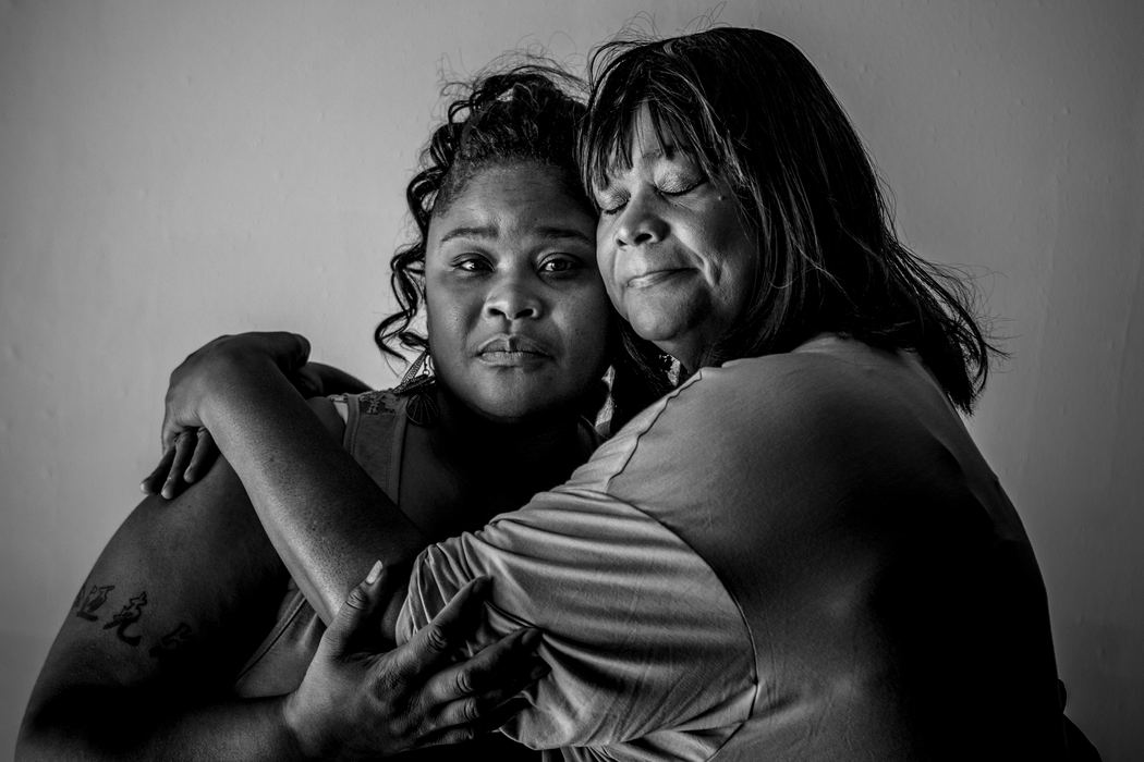 Second Place, Portrait Personality - Meg Vogel / Cincinnati EnquirerRev. Vera Cole embraces her daughter, Jamie Harris, at Keys of the Kingdom United Methodist Church. They fear for the life of their 21-year-old grandson and son, Michael Kinebrew. "It feels like it's open season on black men," Cole says. "It's enough to shake your faith. Why are we targeted?" Kinebrew has been pulled over several times, but his grandmother and mother worry that the next time will be his last.