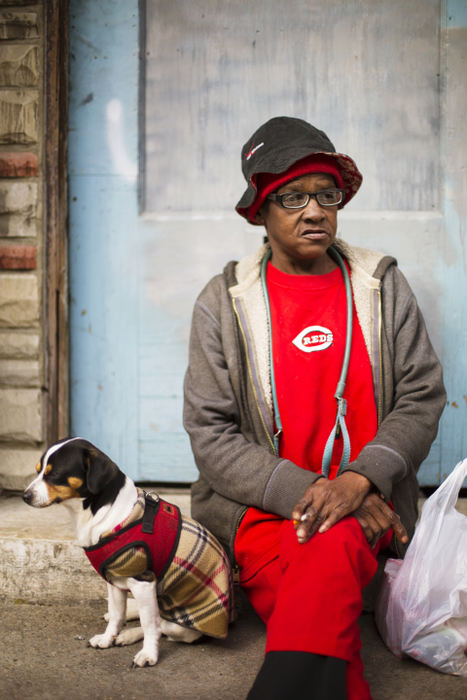 Third Place, Portrait Personality - Carrie Cochran / Cincinnati EnquirerGloria Ballert, of Over-the-Rhine sits with her dog Bear, sits, waiting for the Opening Day parade commemorating the first Reds baseball game of the season, to begin. After talking about the neighborhood, which just marked the 15th anniversary of the death of Timothy Thomas, an unarmed black man by police, the tone became somber. “I want a peace of mind living here. Not just for black people or white people, but for everybody. We don’t need shooting around here anymore,” she said. “I’m here to enjoy the day with Bear. He’s my protector.”