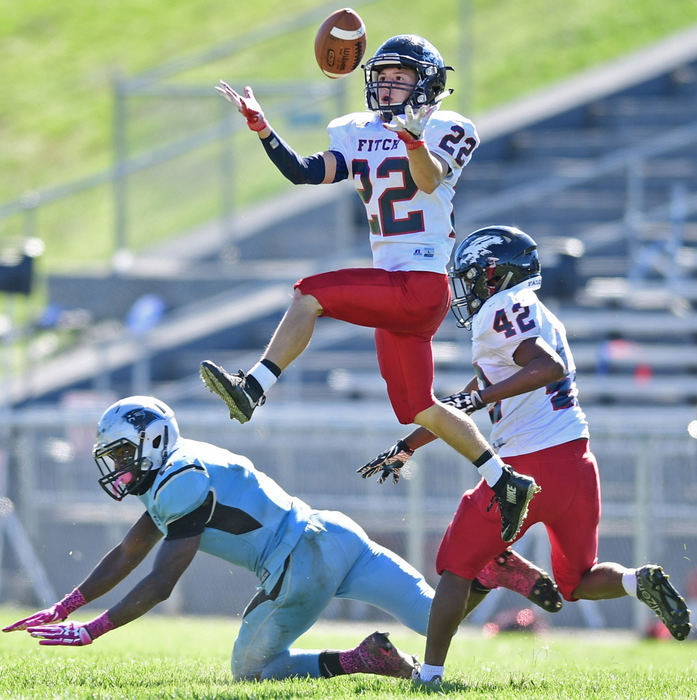Third Place, Sports Action - David Dermer / FreelanceJ.C. Mikovich of Fitch looks the ball into his hands while flying through the air to intercept a pass intended for Michael Lawrence of East during the first half of their game at Rayen Stadium. Fitch won 38-6. 