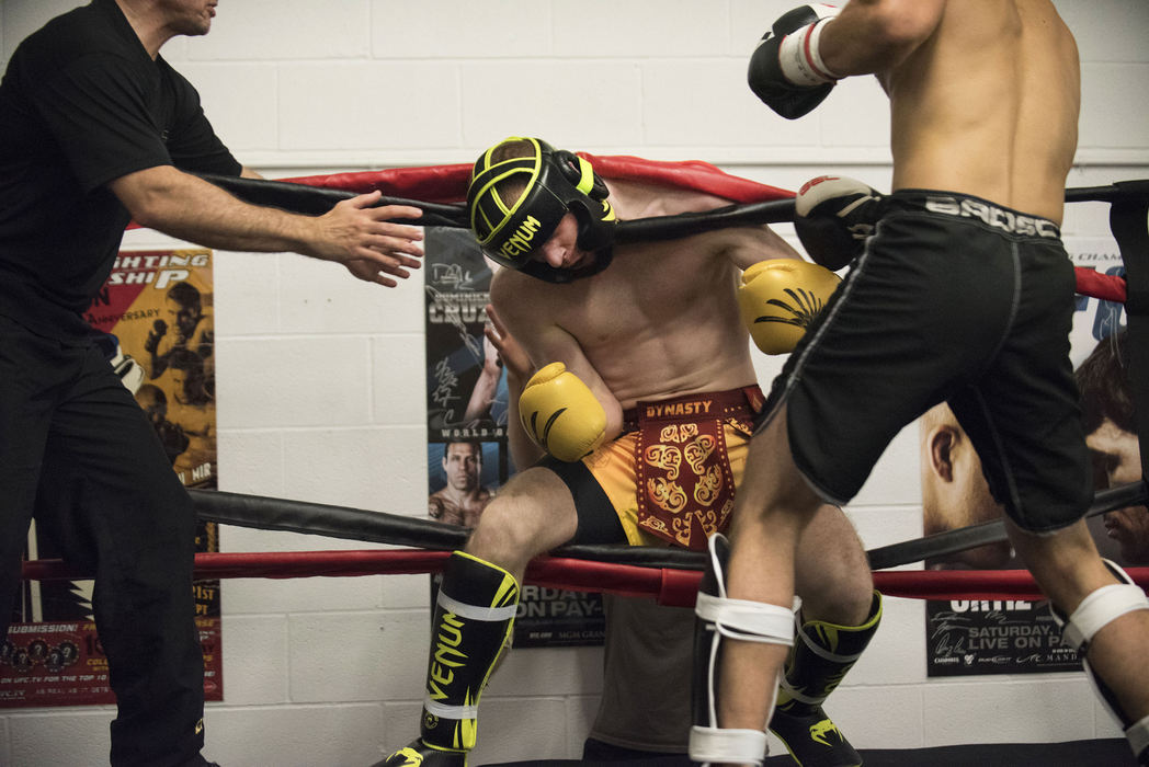 Award of Excellence, Sports Action - Clint Datchuk / Kent State UniversityJosuha Warters hangs in the ropes by his neck after being knocked through them by Josh Belle’s barrage of punches during a kickboxing ‘smoker’ at GriffonRawl Academy in Mentor.