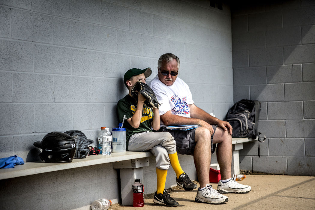 First Place, Ron Kuntz Sports Photographer of the Year - Jessica Phelps / Newark AdvocateTerrie Hill, the man in charge of running the Shrine Tournament, comforts his grandson, while the rest of his team take the field. The team, Subway, lost in the quarterfinals of the farm division. 