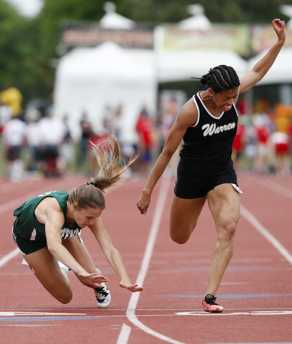 Second Place, Ron Kuntz Sports Photographer of the Year - Joshua A. Bickel / ThisWeek Community NewsDublin Coffman's Abby Steiner, center, falls toward the finish line as she races with Warren G. Harding's Justice Richardson, right, during the girls 100-meter dash final at the OHSAA Division I track and field state championships on Saturday, June 4, 2016 at Jesse Owens Memorial Stadium at The Ohio State University in Columbus, Ohio. Though she tripped and fell, Steiner won the event with a time of 11.87 seconds.  Richardson placed second in 11.89 seconds.
