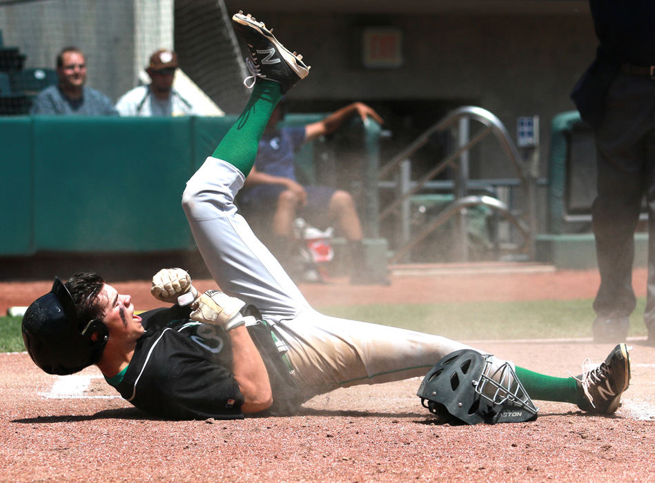 First Place, Ron Kuntz Sports Photographer of the Year - Jessica Phelps / Newark AdvocateThomas Staab celebrates after sliding safely into home plate, scoring the first run of the game. Clear Fork took on Waynedale in the Division III state semifinals but lost 6-3.