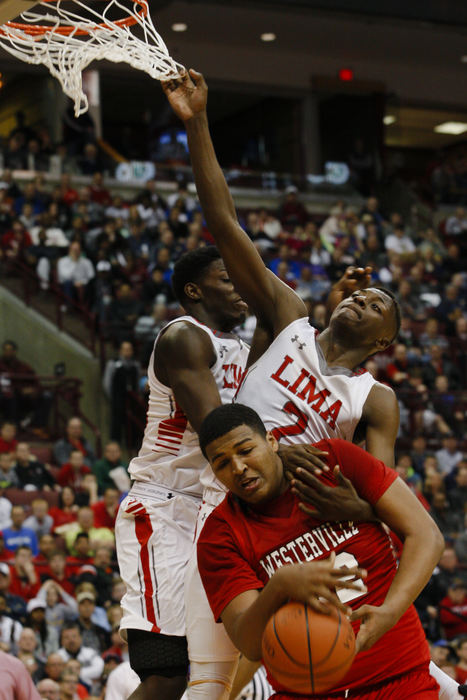 Second Place, Ron Kuntz Sports Photographer of the Year - Joshua A. Bickel / ThisWeek Community NewsWesterville South center Kaleb Wesson, bottom, fights for a rebound with Lima Senior guard Jarius Ward (2) during the first half of the OHSAA Division I boys basketball state championship between the Westerville South Wildcats and the Lima Senior Spartans on Saturday, Mar. 19, 2016 at Value City Arena in Columbus, Ohio.