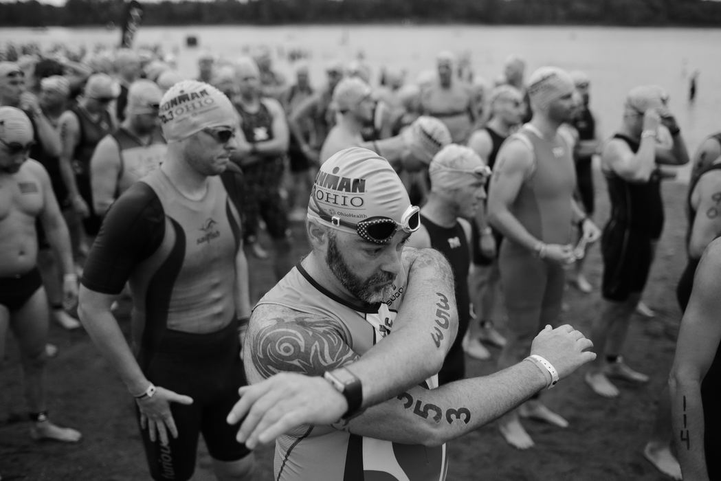 Second Place, Ron Kuntz Sports Photographer of the Year - Joshua A. Bickel / ThisWeek Community NewsMatthew Bowen, of Louisville, Kentucky, stretches out his arms and shoulders before starting a 1.2-mile swim during the Ironman 70.3 Ohio triathlon on Sunday, August 21, 2016 at Delaware State Park in Delaware, Ohio.