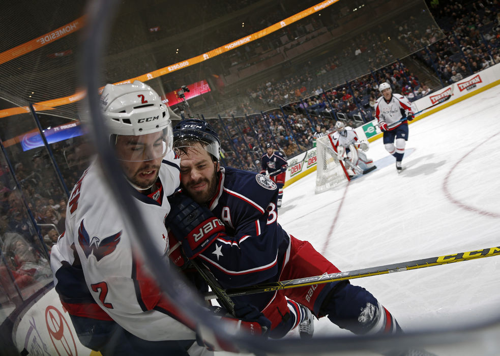 Third Place, Ron Kuntz Sports Photographer of the Year - Kyle Robertson / The Columbus DispatchColumbus Blue Jackets center Boone Jenner (38) checks Washington Capitals defenseman Matt Niskanen (2) into the boards in the 1st period during their NHL game at Nationwide Arena in Columbus, Ohio on November 14, 2016.  