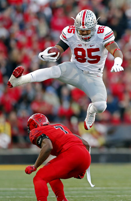 Third Place, Ron Kuntz Sports Photographer of the Year - Kyle Robertson / The Columbus DispatchOhio State Buckeyes tight end Marcus Baugh (85) leaps over Maryland Terrapins defensive back JC Jackson (7) after making a catch during the 1st half at Maryland Stadium in College Park, Md. on November 12, 2016.  