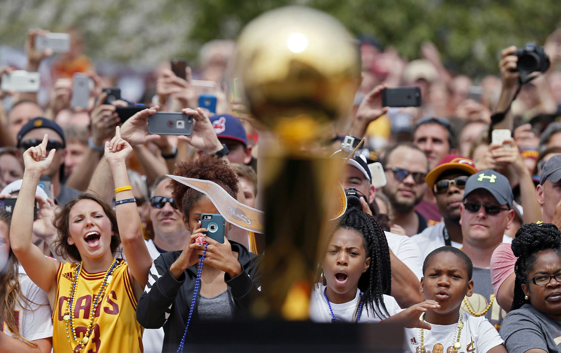 Third Place, Ron Kuntz Sports Photographer of the Year - Kyle Robertson / The Columbus DispatchCleveland Cavalier fans looks at the Larry O'Brien Trophy during the NBA Championship parade outside Quicken Loans Arena in downtown Cleveland on June 22, 2016. 