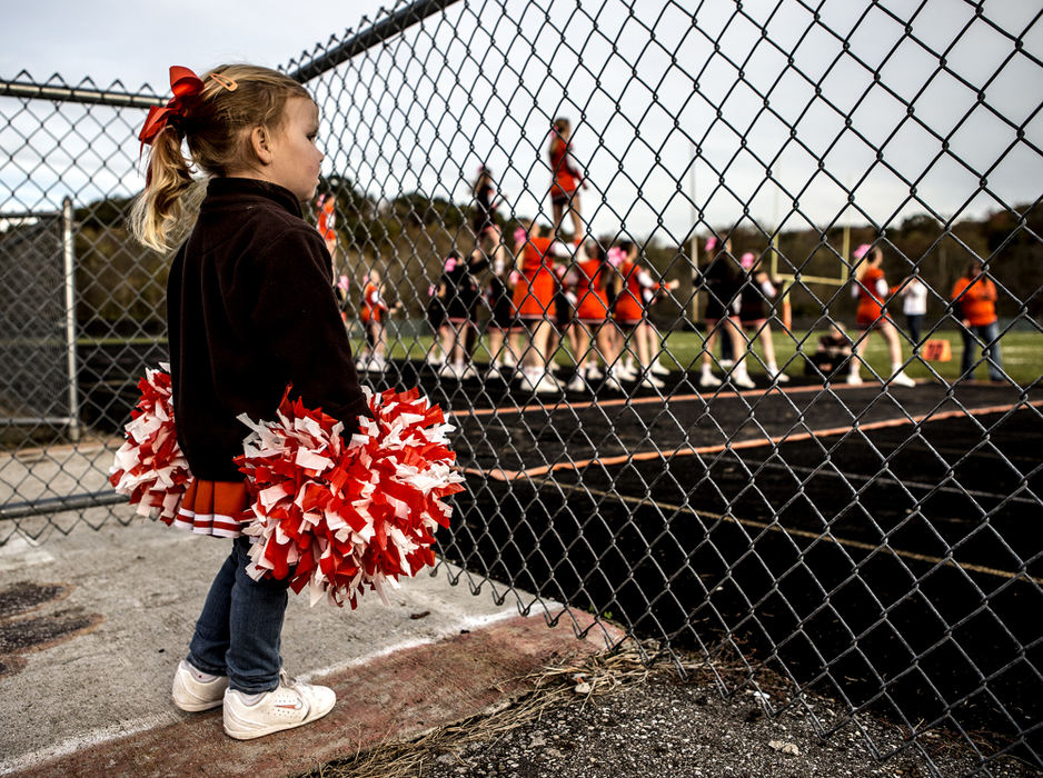 First Place, Ron Kuntz Sports Photographer of the Year - Jessica Phelps / Newark AdvocateDelanie Pettit, 3, angry her mom will not allow her to go onto the field with the Heath high School cheerleading squad, watches from the sidelines as the girls warm up before the game. 