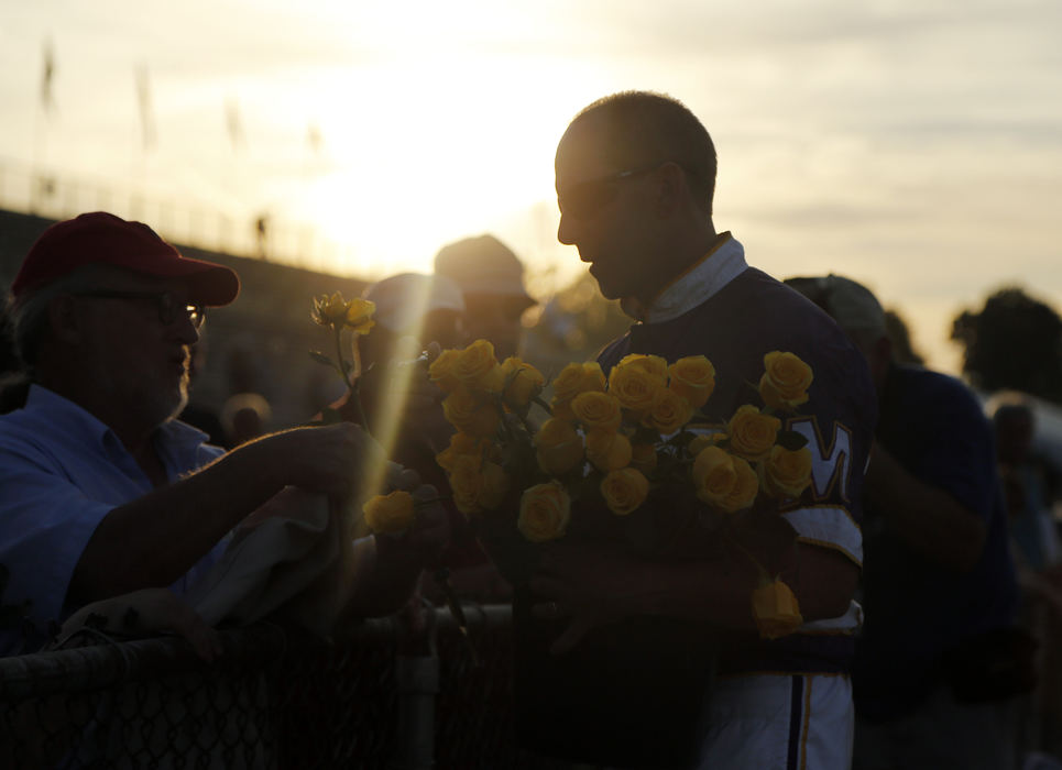 Third Place, Ron Kuntz Sports Photographer of the Year - Kyle Robertson / The Columbus DispatchBetting Line driven by David Miller passes out yellow roses after winning the 71st Little Brown Jug for the 4th time in Delaware, Ohio on September 22, 2016.  