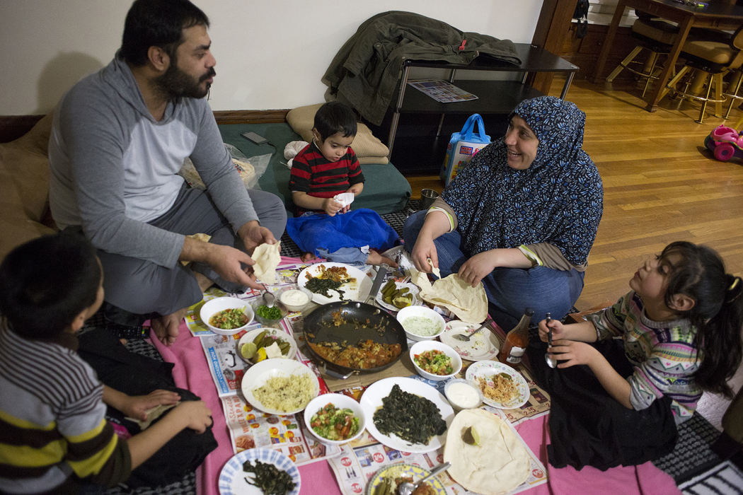 Second Place, Chuck Scott Student Photographer of the Year - Eslah Attar / Kent State UniversityThe family enjoys a homecooked meal after the end of a long day.