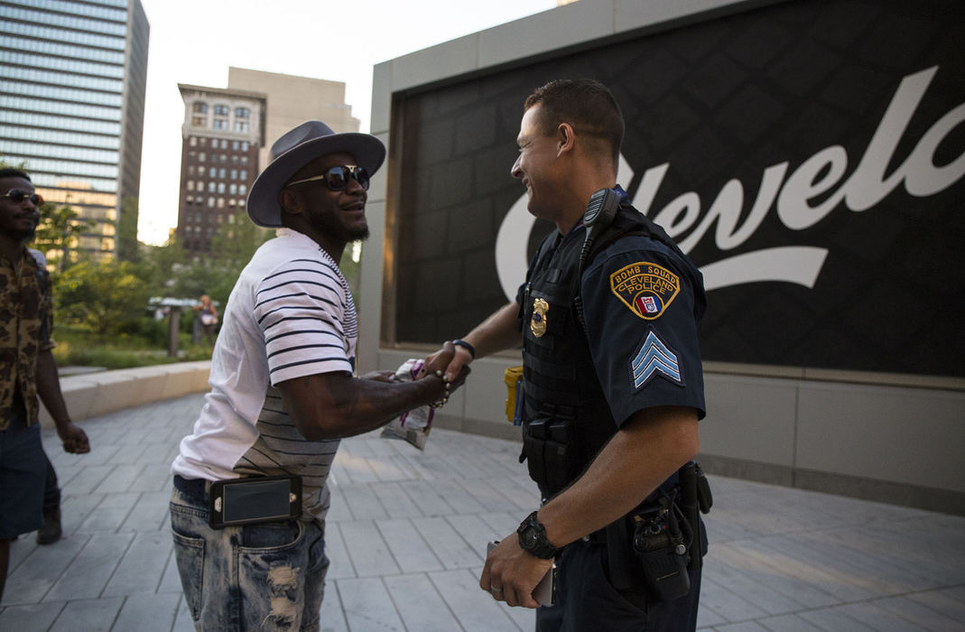 First Place, Chuck Scott Student Photographer of the Year - Andrea Noall / Kent State UniversitySergeant Timothy Maffo-Judd shakes hands with a visitor outside of Tower City in downtown Cleveland on Wednesday, July 20, 2016. 