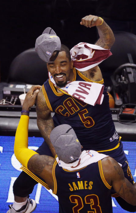 Second Place, Sports Picture Story - Gus Chan / The Plain DealerCleveland Cavaliers guard J.R. Smith jumps in the arms of LeBron James after the Cavs defeated the Toronto Raptors 113-87 in the Eastern Conference Finals. 