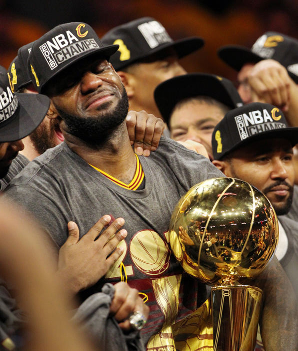 Second Place, Sports Picture Story - Gus Chan / The Plain DealerTears flow as Cleveland Cavaliers forward LeBron James holds the Larry O'Brien NBA Championship Trophy after the Cavaliers defeated the Golden State Warrors 93-89.  