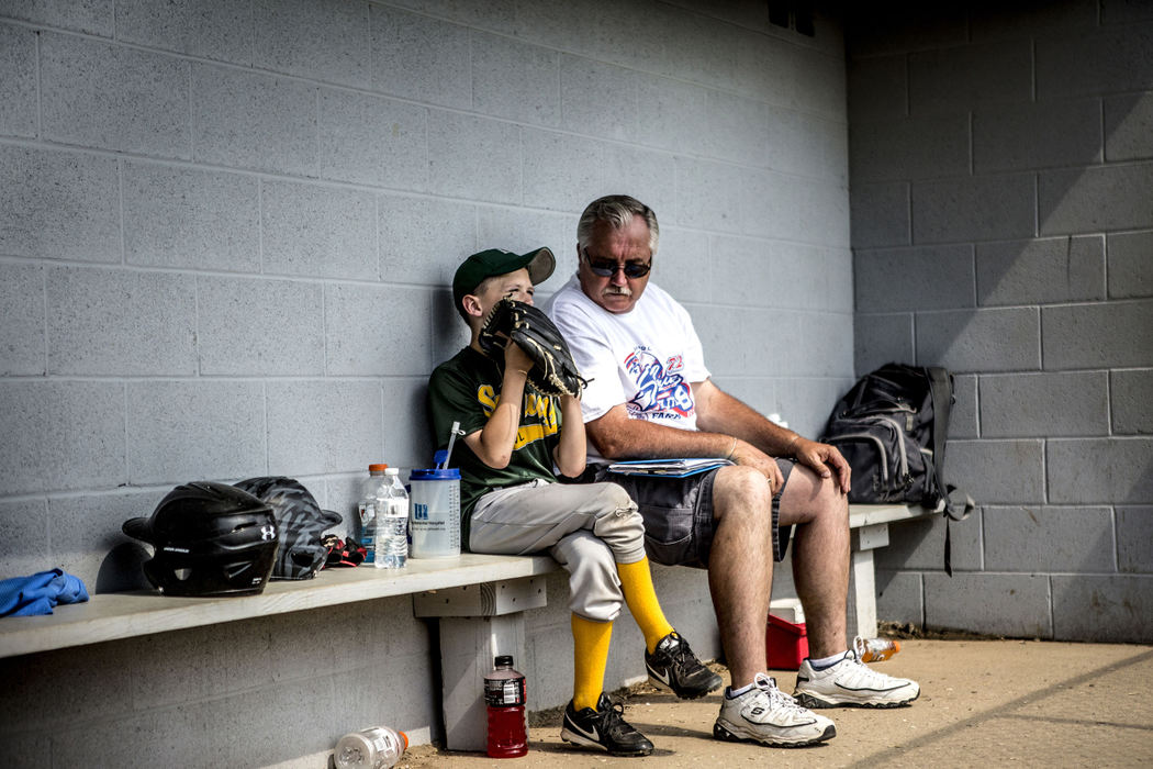 First Place, Sports Picture Story - Jessica Phelps / Newark AdvocateTerrie Hill, the man in charge of running the Shrine Tournament, comforts his grandson, while the rest of his team take the field. The team, Subway, lost in the quarterfinals of the farm division. 
