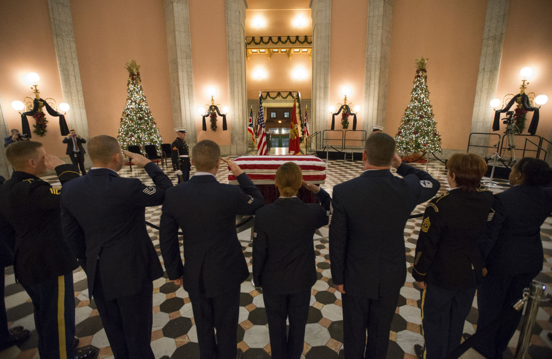 Award of Excellence, Team Picture Story - Adam Cairns / The Columbus DispatchPrior to leaving for the night, volunteers from the Ohio National Guard salute former astronaut and senator John Glenn as his body lies in honor in the rotunda of the Ohio Statehouse on Dec. 16, 2016. Glenn died on Dec. 8 at the age of 95. The volunteers spent the day corralling visitors to the statehouse. 