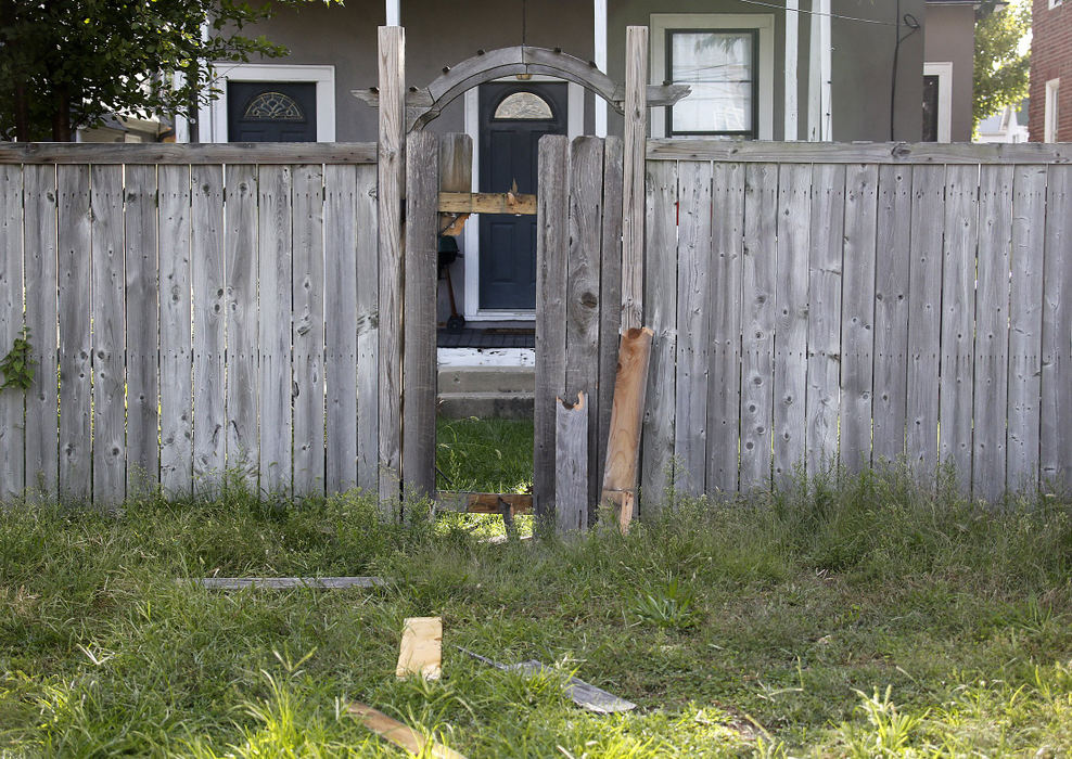 First Place, Team Picture Story - Jonathan Quilter / The Columbus DispatchThe gate behind a house on Hoffman Avenue that was knocked down by Tyre King, 13, and his friend Demetrius Braxton, 19, on Sept. 14, 2016 as they fled from Columbus Police. King was fatally shot as he pulled a gun, which turned out to be a BB gun, from his waistband during the incident. Protests and pleas from the black community ensued following King's death.