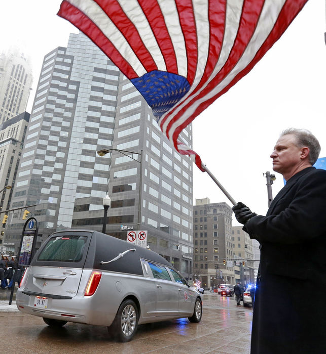 Award of Excellence, Team Picture Story - Barbara J. Perenic / The Columbus DispatchPaul Valenti of Powell holds an America flag as the hearse carrying Sen. John Glenn's body passes by at the corner of Broad and High Streets on its way to Mershon Auditorium on Saturday, December 17, 2016.