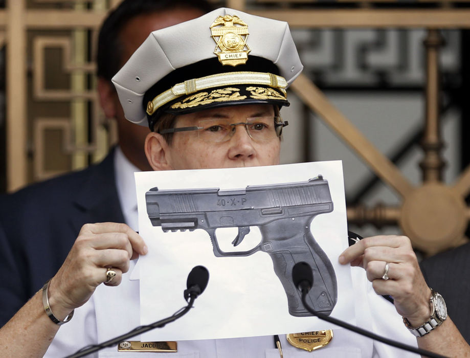 First Place, Team Picture Story - Fred Squillante / The Columbus DispatchDuring a press conference on Sept. 15 at City Hall, Columbus Police Chief Kim Jacobs holds a photo of the kind of BB gun used by 13-year-old Tyre King, who was shot multiple times by officer Bryan Mason. 