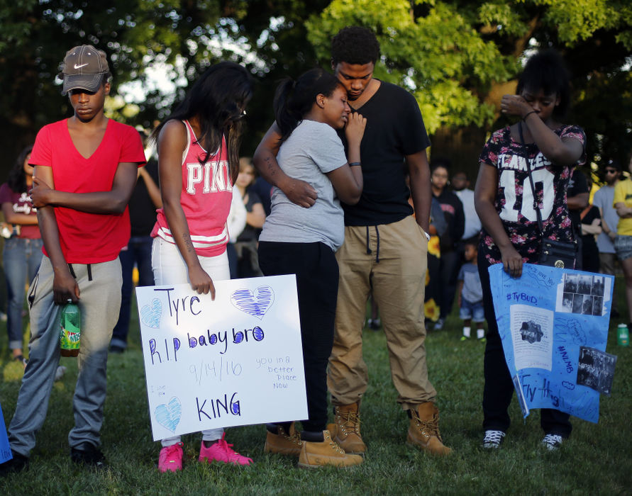 First Place, Team Picture Story - Kyle Robertson / The Columbus DispatchFamily and friends holds each other during a vigil for 13-year-old Tyre King after he was shot and killed by Columbus Police in Columbus, Ohio on Sept. 15, 2016. 