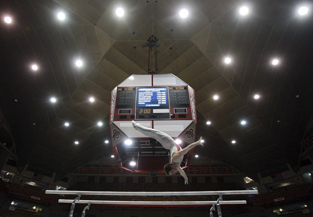 Story - 1st place - Ohio State's Jeff Treleaven goes to the air in the Parallel Bars during the 2011 National Collegiate Men's Gymnastics Championships at St. John Arena. (Kyle Robertson / The Columbus Dispatch)