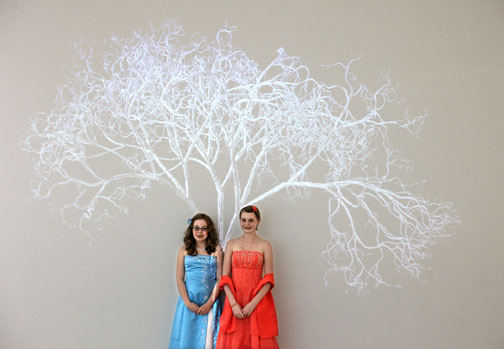 Feature - 2nd place - Victoria LaPlante (right) and her friend Taylor Panzarella pose for a picture for her mother underneath a digital projection of a tree at the Cleveland Clinic. Prom attendees were treated to a catered affair at the clinic before heading to the Ritz Carlton.  The prom is sponsored by The Unforgettable Prom Foundation, Inc., a non-profit that provides memorable nights to kids with cancer.  (Lisa DeJong / The Plain Dealer)