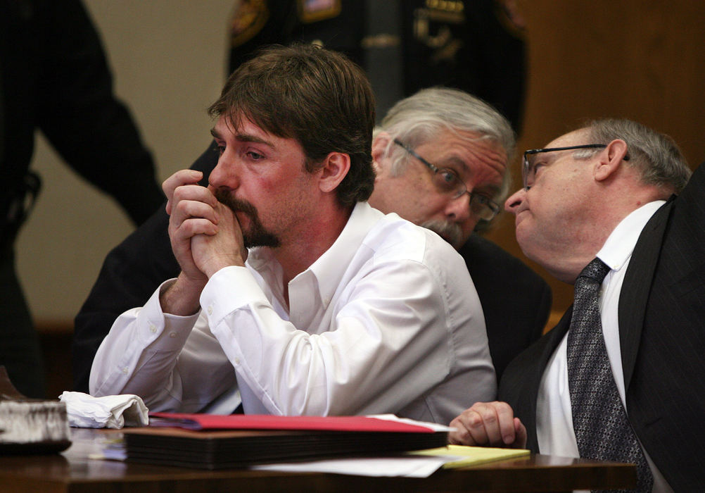 General News - 3rd place - Sammy Littleton II (left) pleaded guilty to three counts of aggravated murder and three counts of gross abuse of a corpse during his arraignment in Logan County Common Pleas court. Here, Littleton sits while his attorneys Randall Porter (middle) and Marc S. Triplett (right) converse.  (Jonathan Quilter / The Columbus Dispatch)