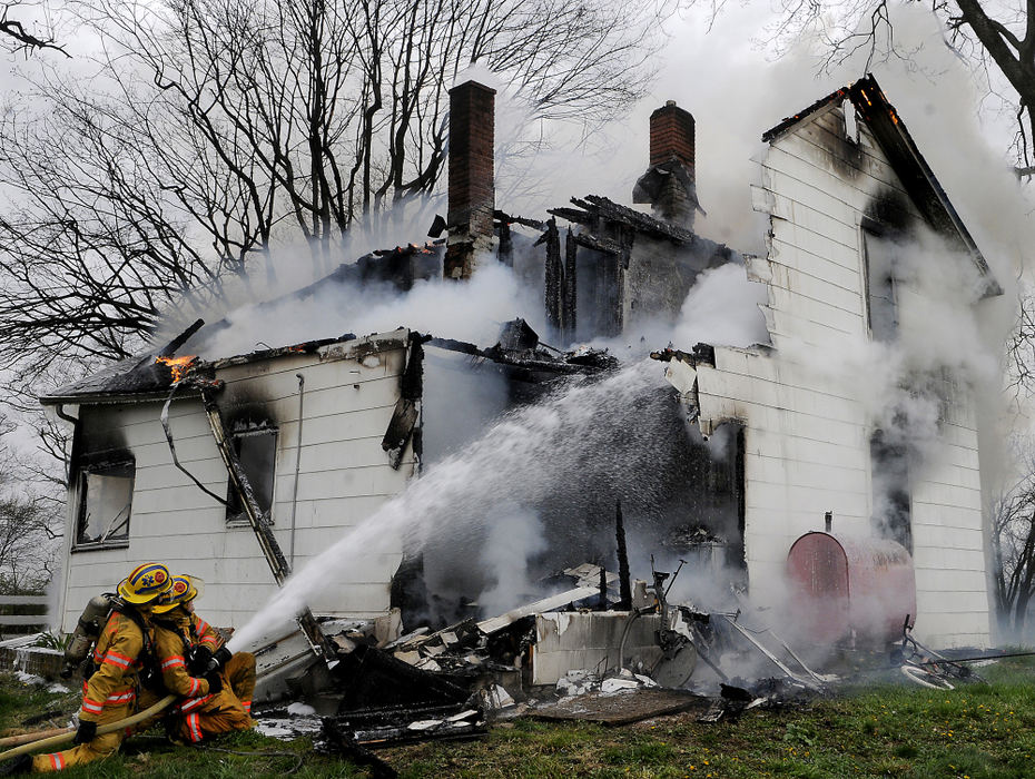 Spot News - 1st place - A two story farmhouse on South River Road in Clifton caught fire  according to Hustead Volunteer Firemen Association. The fire started in the back of the house and engulfed the home by the time firefighters arrived, said Lt. Heath Friessen. Five townships responded to the fire. No one was in the home at the time of the fire. (Marshall Gorby / Springfield News-Sun)