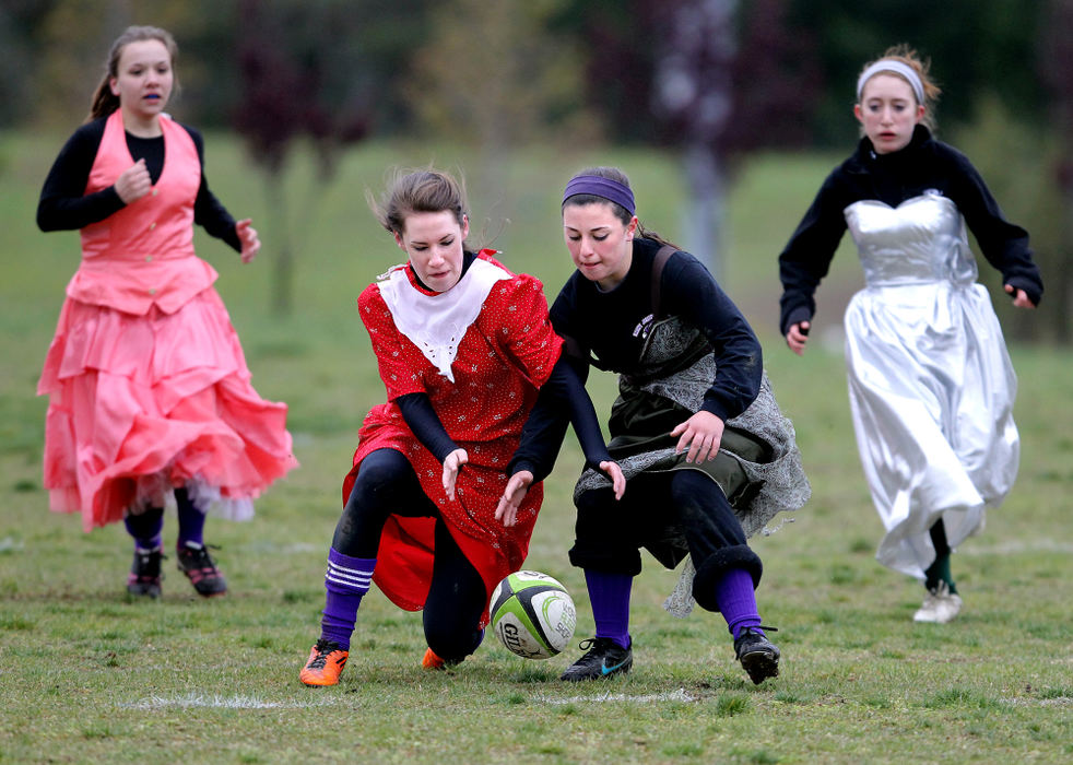 Sports - 1st placeSt. Joseph's Michelle Roman, 17, left in front, and St. Joseph's Erin McGinty, 14, (right) who was playing for Medina in this game, go for the ball during the Prom Dress Rugby Tournament in North Ridgeville.  In background on left is St. Joseph's Ashley Kocian, 15, and on right in background is Medina's Rochelle Keller, 15. Five girls' rugby teams participated in this fundraiser that will benefit The Smile Train who is holding The Smile Train Triathlon on June 24. ( Lisa DeJong / The Plain Dealer)