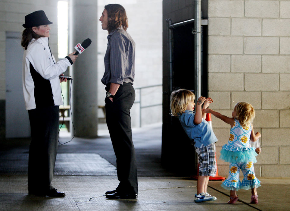 Sports Feature - 1st placeWhile dad Frankie Hejduk (center) talks to 97.1 The Fan reporter Lori Schmidt (left) about his retirement from playing professional soccer, Hejduk's children Cali, 1, far right, and Coasten, 4, second from right, engage in play of their own. Hejduk will join the Crew's front office as a brand ambassador. (Fred Squillante / The Columbus Dispatch)