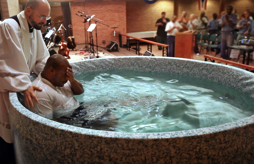 Story - 1st placeMarion Correctional Institution Chaplin Timothy Smith (left) baptizies  inmate Charles Jones (right) in the prison Chapel. (Tom Dodge / The Columbus Dispatch)