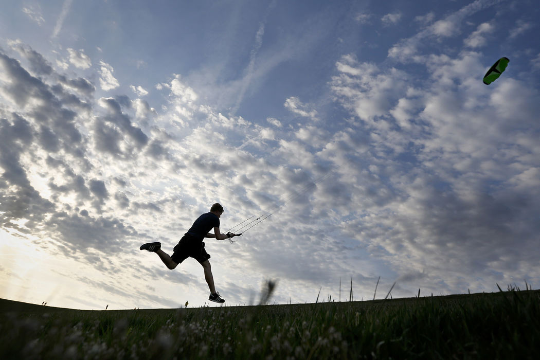 Feature - 3rd placeOlentangy Orange senior Scott Fulton catches some air as he flies a massive kite on the hill at the Alum Creek Below Dam Area.  (Eamon Queeney / The Columbus Dispatch)