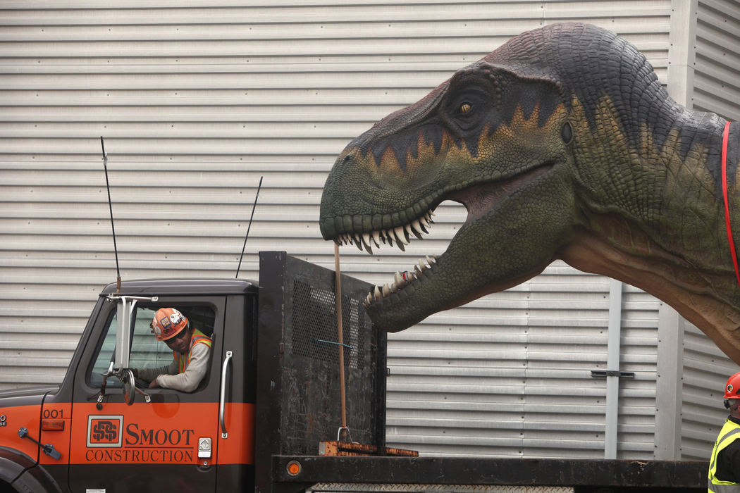 General News - 2nd placeDavid Jackson (left), with Smoot Construction, backs his truck to load a Tyrannosaurus behind the Manatee Coast at the Columbus Zoo and Aquarium.  (Tom Dodge / The Columbus Dispatch)