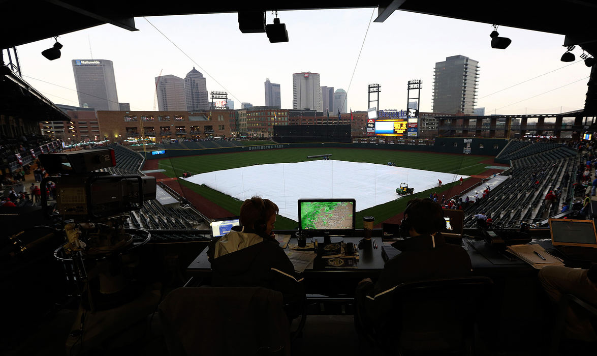 Sports Feature - HMColumbus Clippers radio broadcast team of Ryan Mitchell (left) and Scott Leo,  look at the local radar while letting listeners know that the game was postponed due to inclement weather at Huntington Park in Columbus.  (Kyle Robertson / The Columbus Dispatch)