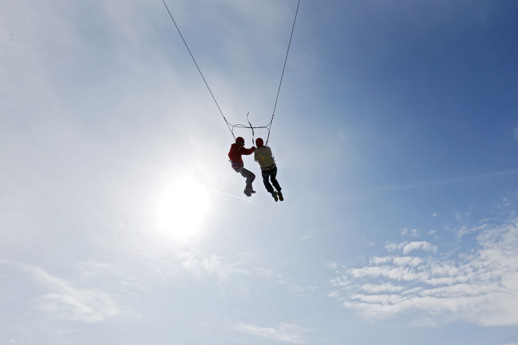 Story - 3rd placeSteve Meyer hangs onto sister Susan Meyer, both of Cincinnati, as they  swing . (Eric Albrecht / The Columbus Dispatch)