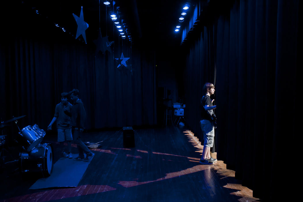 SFeature - 3rd place - Seventh grader Seth Peacock takes a peek through the curtains while his bandmates Henry Morris and Paul Martinez-Watkins make final preparations before performing during a rehearsal for the upcoming Dominion Middle School talent show.   (Ryan M.L. Young / ThisWeek Community News)