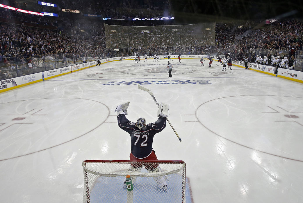 Sports Feature - 3rd place - Columbus Blue Jackets goalie Sergei Bobrovsky (72) celebrates after Blue Jackets left wing Nick Foligno (71) scored the game winning goal in overtime against Pittsburgh Penguins during Game 4 of the first-round in Stanley Cup playoffs at Nationwide Arena in Columbus. (Kyle Robertson / The Columbus Dispatch)