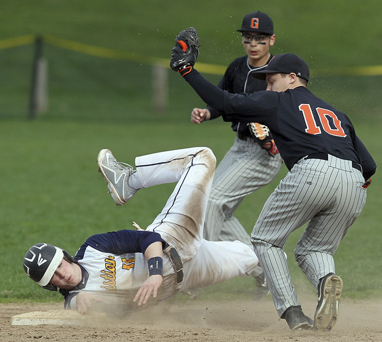    Sports - 3rd place - Toledo Christian's Kyle Kempton (11) tries to steal second base against Gibsonburg's Jordan Kreglow (10) during the first inning of a game in Toledo. (Jeremy Wadsworth / The (Toledo) Blade)