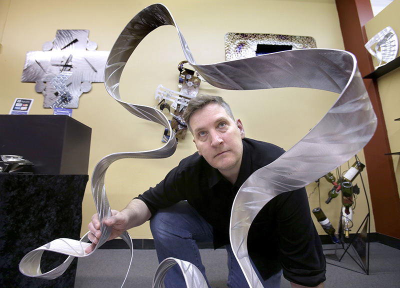 Portrait - HM - Todd Walburn, co-owner of 2nd April Galerie, is shown with the artwork of Scofield Designs and Medalworks that is available in his business in Canton. (Scott Heckel / The (Canton) Repository)