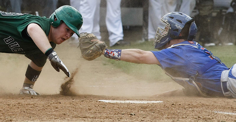 Sports - 1st place - Marysville catcher Grant Howard (right) reaches to tag out Dublin Coffman's Matt Phipps during the Monarchs' game against Dublin Coffman at Dublin Coffman High School. (Joshua A. Bickel / ThisWeek Community News)